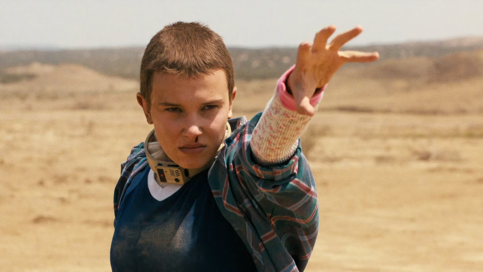 A scene from the TV show Stranger Things, featuring the character Eleven looking overwhelmed and intense, symbolizing the chaos of managing multiple tasks or agent sessions.